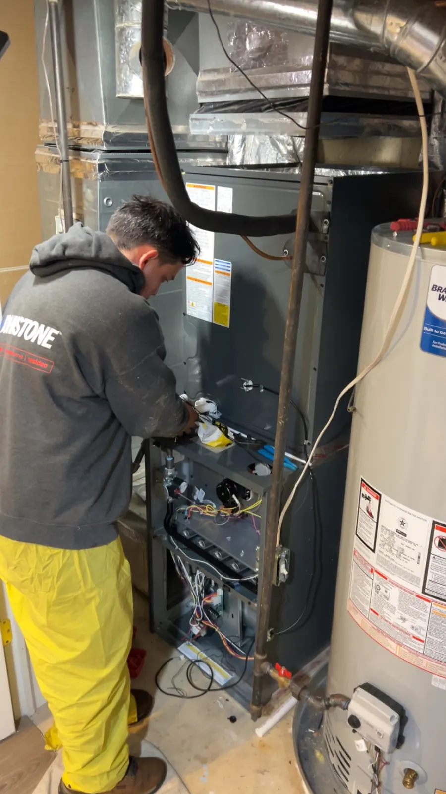 A SwiftPro plumber servicing a water heater